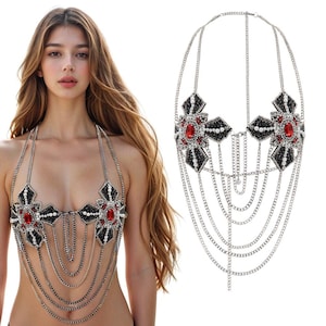 May include: A silver chain body jewelry with black and red beaded flowers. The chain is layered and has a delicate design.