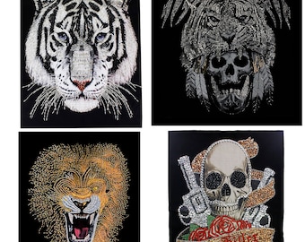 May include: Four iron-on patches featuring animal and skull designs. The first patch is a white tiger head. The second patch is a black and silver tiger head with a skull underneath. The third patch is a lion head with a roaring expression. The fourth patch is a skull with two pistols and a rose.