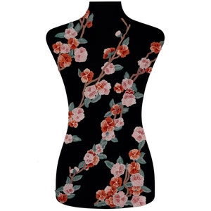 May include: Black fabric with embroidered pink and orange flowers in a floral pattern.