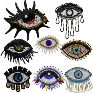 May include: Assortment of eight beaded eye patches in various colors and styles. The eye patches are made with beads and sequins and have a variety of embellishments, including fringe, tassels, and pearls.