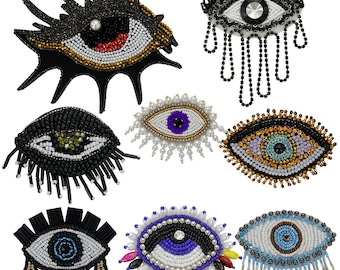 May include: Assortment of eight beaded eye patches in various colors and styles. The eye patches are made with beads and sequins and have a variety of embellishments, including fringe, tassels, and pearls.