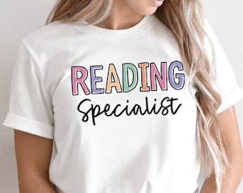 May include: White t-shirt with the text "READING Specialist" in colourful letters.