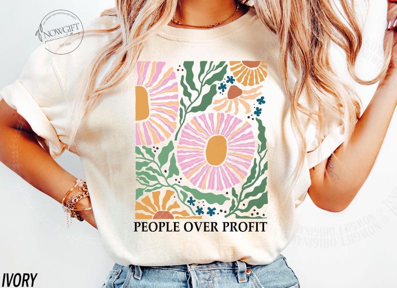 May include: A white t-shirt with a floral design and the text "PEOPLE OVER PROFIT" printed on the front. The flowers are pink, orange, and yellow.