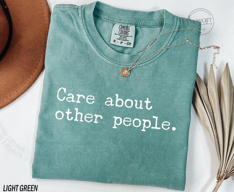 Puede incluir: Camiseta verde claro con el texto "Care about other people." impreso en blanco.