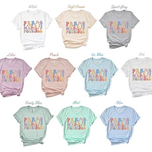 May include: A set of ten t-shirts in various colors featuring the text "PARAS MAKE IT POSSIBLE" in a rainbow-colored retro font.