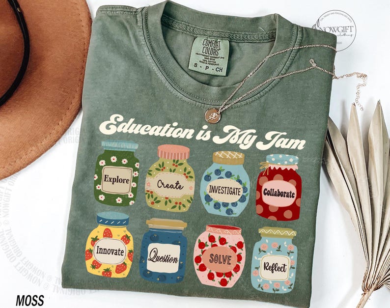 May include: Green t-shirt with the text "Education is My Jam" and a design of jars with different words on them, including "Explore", "Create", "Investigate", "Collaborate", "Innovate", "Question", "Solve", and "Reflect".