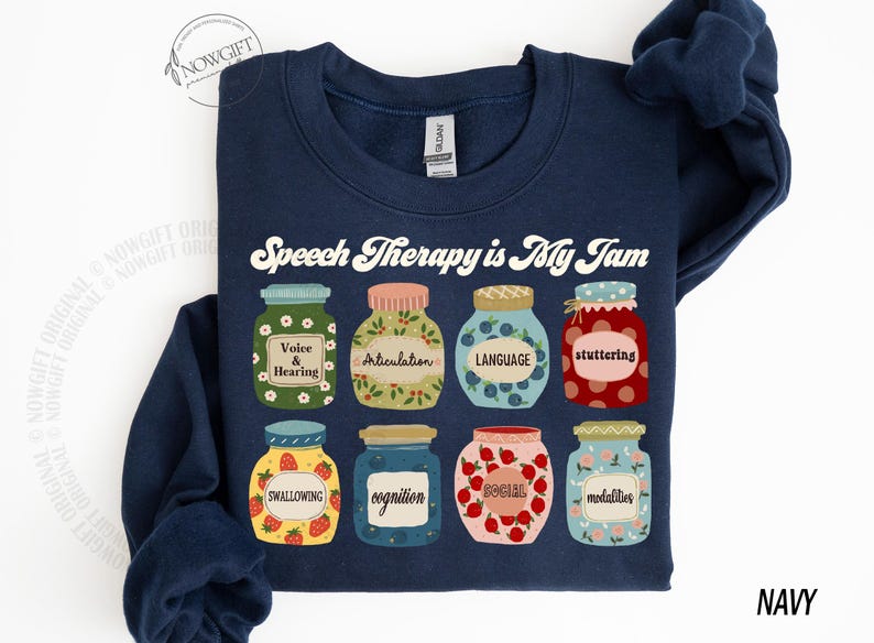 May include: Navy blue sweatshirt with the text "Speech Therapy is My Jam" in white. The sweatshirt features a row of nine colorful jars with different speech therapy related words on them.