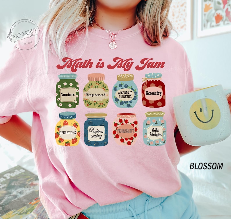 May include: Pink t-shirt with the text "Math is My Jam" and a graphic of jars with different math concepts, such as numbers, measurement, algebraic thinking, geometry, operations, problem solving, probability, and data analysis.