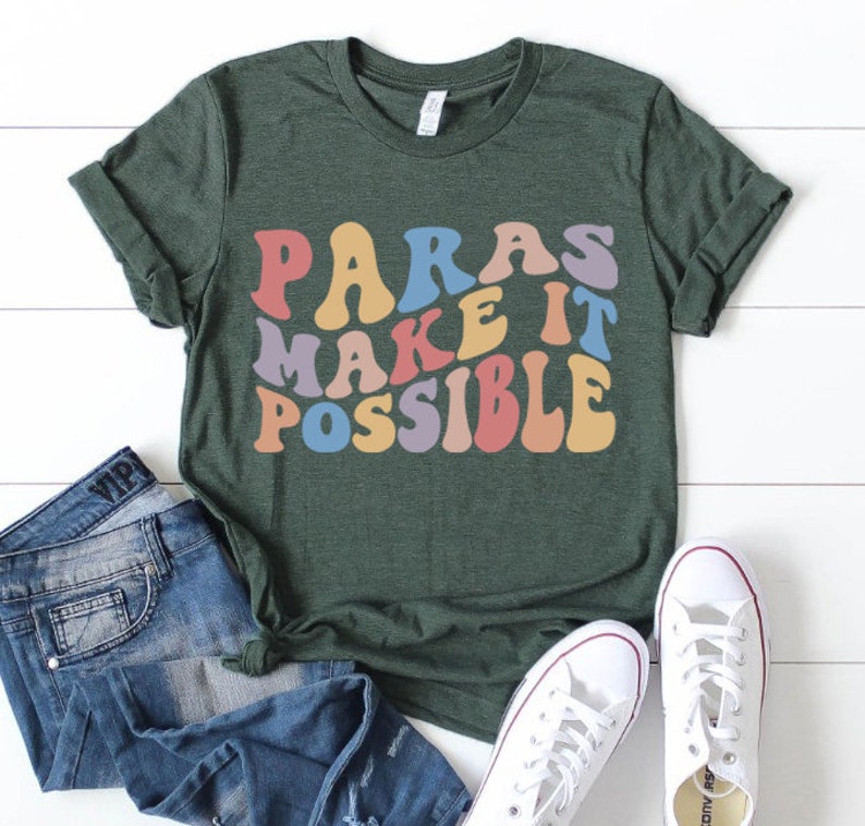 May include: A green t-shirt with the text "Paras Make It Possible" in rainbow colors. The text is in a retro, groovy font.