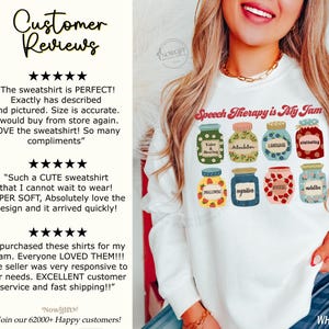May include: White sweatshirt with the text "Speech Therapy is My Jam" and a graphic of eight jars with different speech therapy related words on them. The jars are decorated with flowers and strawberries.