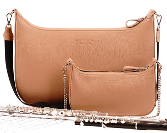 Peut inclure: Deux sacs à main en cuir de couleur sable avec une bandoulière en chaîne argentée et une fermeture éclair argentée. Une flûte argentée est posée sur une feuille de musique.