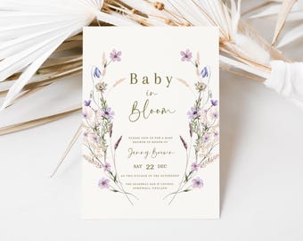 May include: A baby shower invitation with a floral wreath design. The text reads "Baby in Bloom" and includes the date and time of the event. The invitation is for Jenny Brown.
