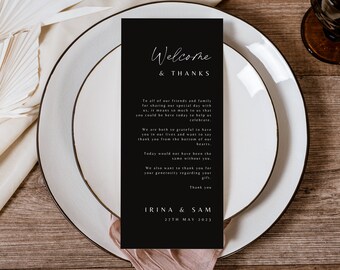Könnte beinhalten: Schwarzes und weißes Hochzeitsschild mit dem Text "Willkommen & Danke" und einer Nachricht, die den Gästen für ihre Teilnahme an der Hochzeit von Irina & Sam am 27. Mai 2023 dankt.