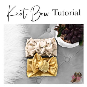 May include: Two fabric hair bows, one with a floral print and one in a solid gold velvet. The bows are tied in a knot and are displayed on a gray textured surface.