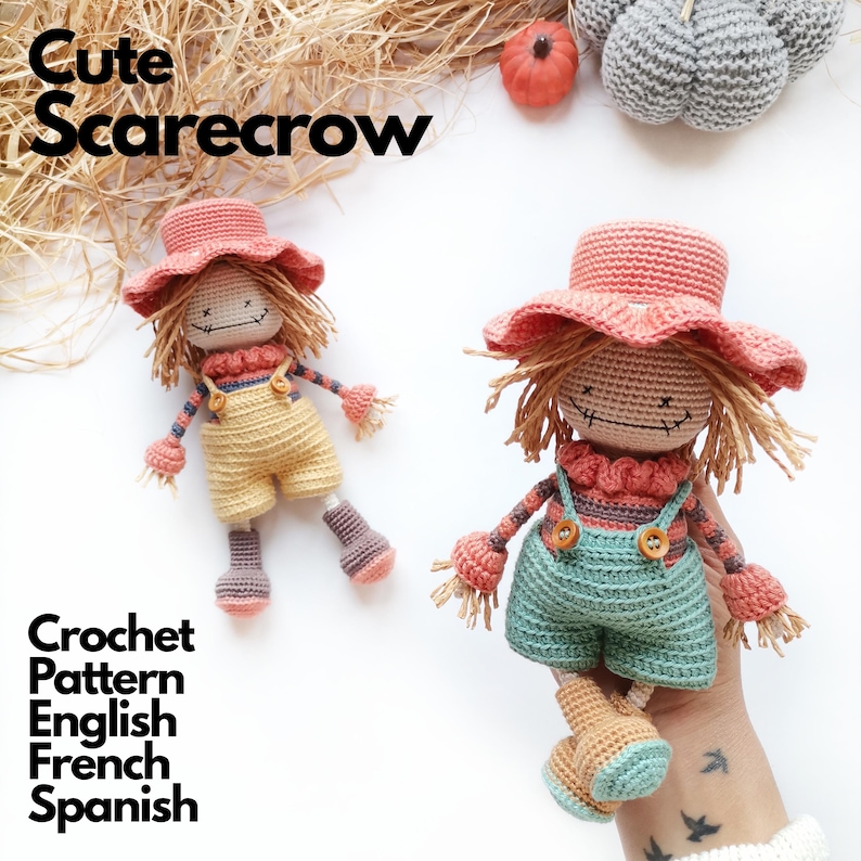 May include: Two handmade crochet scarecrow dolls featuring straw-like hair, wide-brimmed hats, and overalls. One doll wears yellow overalls, the other wears teal overalls with wooden buttons. The text Cute Scarecrow Crochet Pattern English French Spanish is visible.