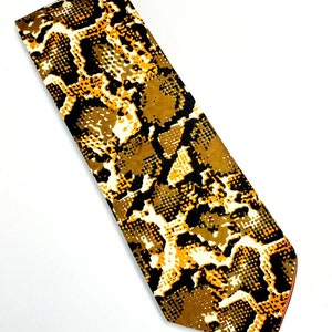 May include: A brown and yellow tie with a snakeskin pattern.