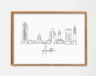 Peut inclure: Un dessin au trait noir et blanc de l'horizon d'Austin, au Texas. Le dessin est encadré dans un cadre en bois clair et est accroché à un mur blanc. Le dessin comprend le bâtiment du Capitole de l'État du Texas et d'autres bâtiments emblématiques d'Austin.