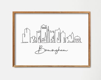 Puede incluir: Un dibujo en blanco y negro de la línea del horizonte de Birmingham con el nombre de la ciudad escrito debajo. El dibujo está enmarcado en un marco marrón claro y está colgado en una pared blanca.