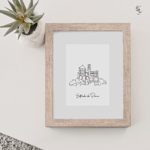 May include: A black and white line drawing of the Pena Palace in Sintra, Portugal. The drawing is framed in a light brown wood frame. The text "Estoril do Pena" is written below the drawing.