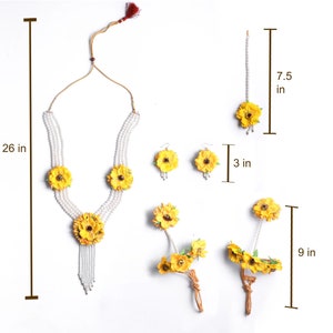 May include: A yellow flower jewelry set with a pearl necklace, earrings, a maang tikka, and two bangles. The necklace is 26 inches long, the earrings are 3 inches long, the maang tikka is 7.5 inches long, and the bangles are 9 inches long.