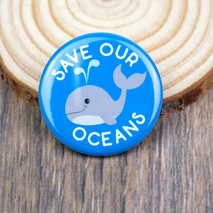 May include: Blue button with the text "Save Our Oceans" and a cartoon whale with a spout of water on top of it.