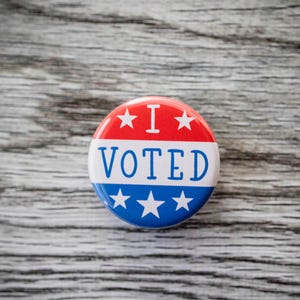 May include: A red, white, and blue button with the text "I VOTED" and stars around the edge.
