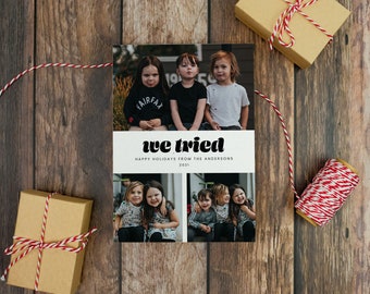 May include: A Christmas card with a white background and a photo of four children. The card says "we tried" in a retro font and "Happy Holidays from the Andersons 2021" in a smaller font.
