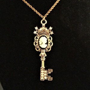 Lovely cameo skeleton key pendant / keychain / décor; Black & white with goldtone and crystals ...somewhat Steampunk vibes, Victorian, Goth