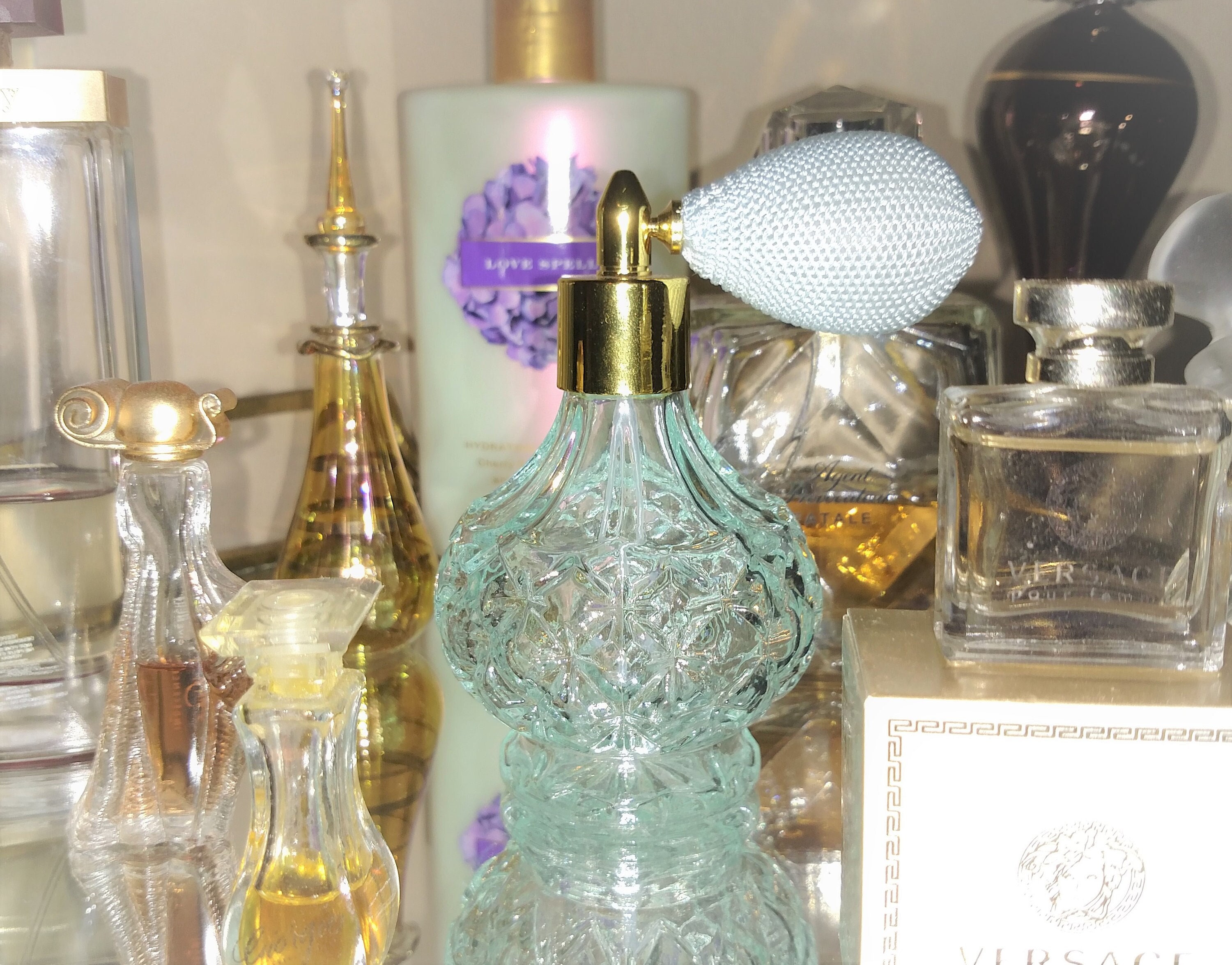 Sky blue perfume atomizer w/ golden trim * Never been used; Totally clean - "puffer" (atomizer) works great! 3.5 inches tall; 3 oz. capacity