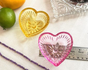 Jewelry catch; heart-shaped crystal ring holder. Bright, deep pink color.  Space around central spire for multiple jewelry pieces.