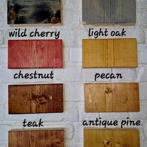 May include: A wood stain color chart with 10 different wood stain colors. The colors are: black ebony, drift grey, wild cherry, light oak, chestnut, pecan, teak, antique pine.