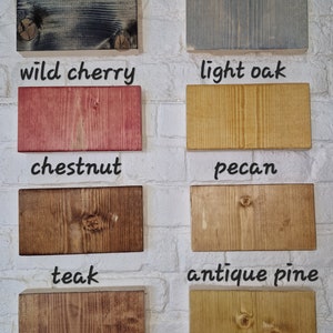 May include: A collection of wood samples in various colors and finishes, including black ebony, drift grey, wild cherry, light oak, chestnut, pecan, teak, and antique pine.
