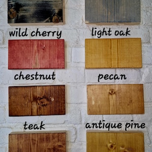 May include: Eight wood samples stained in different colors, including black ebony, drift grey, wild cherry, light oak, chestnut, pecan, teak, and antique pine.