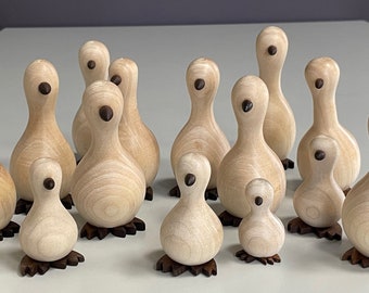 Wooden Goose Families, handcrafted, hardwood ornaments to grace any home.