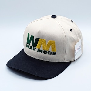 May include: A beige and black baseball cap with a green and yellow embroidered logo that says "WM WAR MODE".