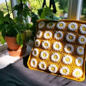 Handmade crochet daisy cushion cover.