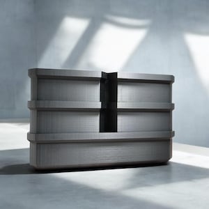 May include: A gray, rectangular, multi-tiered storage unit with a textured surface. The unit has a vertical divider in the center.