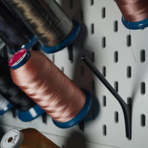 May include: A set of three ceramic mugs with a speckled, matte finish. The mugs are in shades of cream, light gray, and dark gray. Each mug has a simple, minimalist design, perfect for coffee or tea.