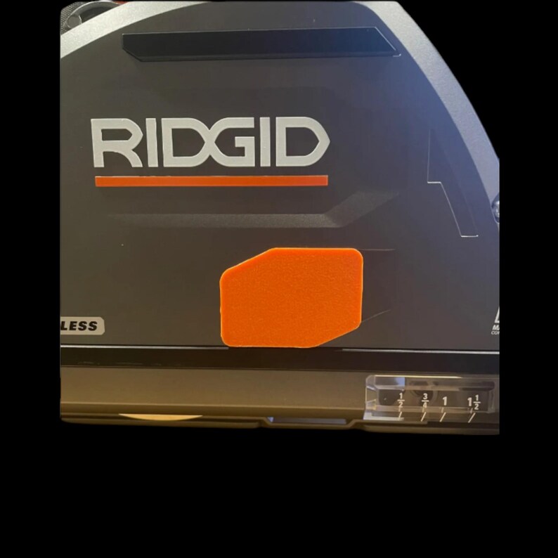 Orange 3D-printed arbor hole cover installed on Ridgid track saw housing
