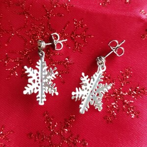 Snowflake Earrings Sale! Free Shipping! Dangle White with a Pearl Finish. Each Post Has a Clear Rhinestone with an Iridescent Finish.