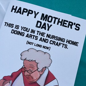 May include: A humorous greeting card with a cartoon illustration of an older woman in a red shirt and white apron, making pottery. The card reads "Happy Mother's Day. This is you in the nursing home doing arts and crafts. (Not long now)"