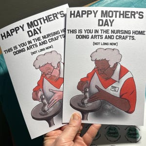 May include: Two greeting cards with a humorous illustration of a person using a pottery wheel. The text on the cards reads "Happy Mother's Day. This is you in the nursing home doing arts and crafts. (Not long now)"
