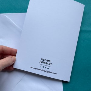 May include: White card with black text that reads "Pics and Squiggles Digital Art and Design" and a website address: www.picsandsquiggles.com. The card is on top of a white envelope.
