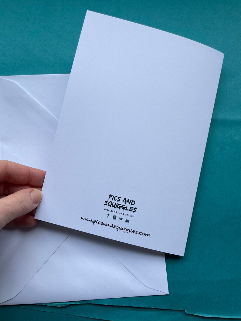 May include: White card with black text that reads "Pics and Squiggles Digital Art and Design" and a website address: www.picsandsquiggles.com. The card is on top of a white envelope.