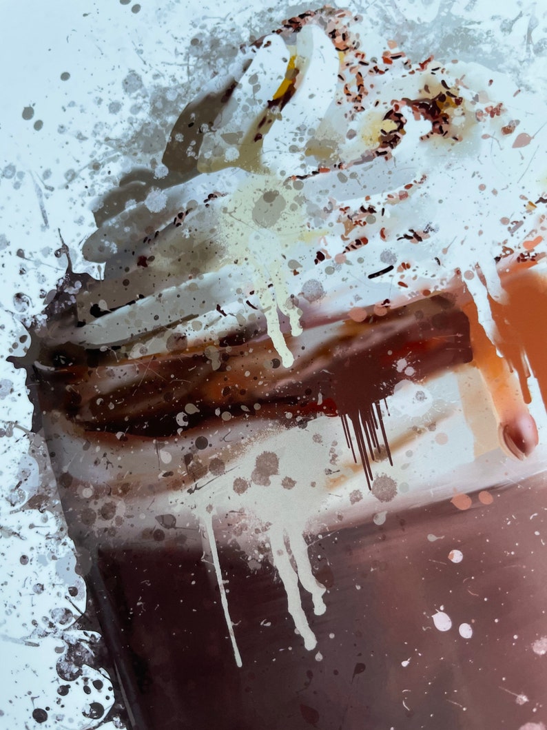 Puede incluir: Un primer plano de un batido de chocolate con crema batida y virutas de chocolate. El batido est&aacute; en un vaso con un fondo marr&oacute;n. La imagen tiene un efecto acuarela con salpicaduras blancas y marrones.