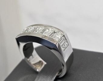 May include: A silver band with a row of square-shaped diamonds set in a channel setting.