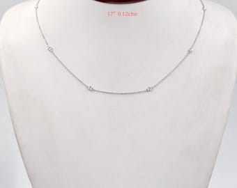 May include: A delicate silver necklace with multiple small, round gemstones evenly spaced along a 17-inch chain. The necklace is displayed on a white mannequin, with the text "17" 0.12ctw" visible.