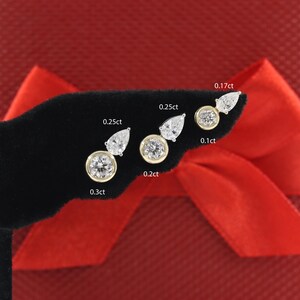 May include: A set of six pairs of diamond earrings in various sizes, ranging from 0.17ct to 0.3ct. The earrings are displayed on a black velvet surface with the carat weight labeled for each pair.