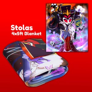 May include: A folded blanket with a colorful cartoon illustration of a character named Stolas. The blanket is 4x5 feet and features a detailed design with shades of purple, red, and white. The image also shows a framed artwork of the same character.