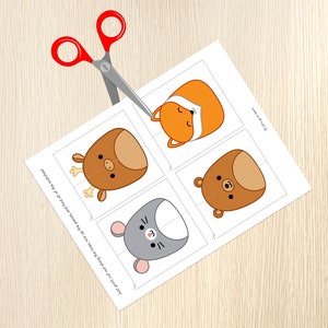 May include: A printable sheet with four animal faces, a fox, a deer, a bear, and a mouse. The sheet is cut out along the lines, ready to be assembled into a matching game.